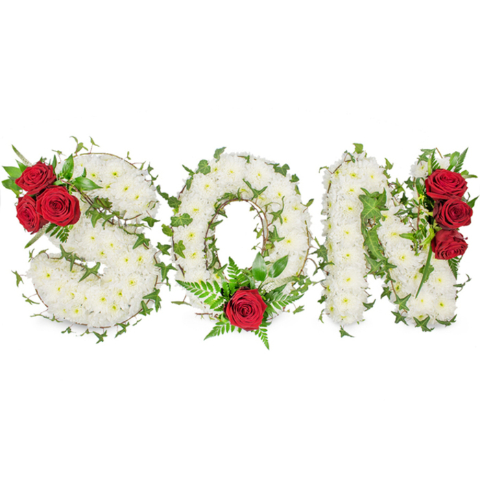A striking, dignified floral statement forms the word 'SON' in bold capitals, each letter densely packed with small, immaculate white spray chrysanthemums that create a reassuringly full, tapestry-like surface. Lush ivy vines are artfully woven through the white masses, delineating contours and lending a natural, almost living edge to the lettering. Strategic clusters of deep red roses punctuate the arrangement and draw the eye: three full blooms tucked into the upper curve of the 'S', a single prominent rose nestled at the lower curve of the 'O' accompanied by delicate fern fronds and fine greenery, and another vertical trio of red roses accenting the right side of the 'N'. The glossy dark leaves supporting the roses add weight and contrast, while the overall palette-pure white, rich crimson, and vibrant green-reads as both elegant and emotionally resonant. The composition sits on a neutral white backdrop and is photographed in soft daylight, which reveals the tender textures of petals and foliage and suggests the gentle fragrance of chrysanthemums mingled with rose. This personalized bereavement arrangement is crafted for use in funeral services, memorial gatherings or on a graveside, and speaks of deep affection and solemn respect. Locally familiar to families attending services near Golders Hill Park, Golders Green tube station or the surrounding community, it embodies the quiet care of an experienced florist shaping tribute and memory.