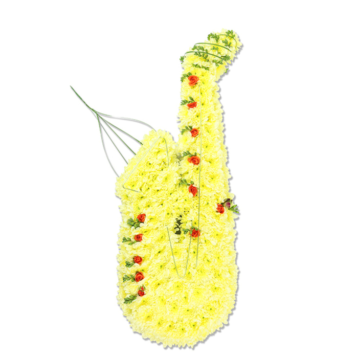 This image shows a meticulously crafted floral saxophone tribute standing upright against a clean, white studio-style background, as if displayed before it begins its journey to a funeral or memorial in Golders Green. The saxophone's familiar sweeping silhouette is modelled entirely in flowers: the body, neck, and flared bell are packed with bright, daisy-like yellow chrysanthemums, layered so densely they form a continuous, velvety blanket of colour. The overall tone is a rich, sunny yellow, catching an even, soft light that highlights the texture of each petal. Interspersed throughout, like shining notes on a musical score, are dainty red spray roses and rosebuds, positioned where the keys and buttons would typically sit. Their deeper red hue gives subtle depth and contrast, punctuating the design and guiding the eye along the length of the instrument. Fine strands of dark green foliage and trailing greenery run alongside the contours, especially around the curved neck and lower section of the bell, providing definition and a natural outline that suggests metal tubing translated into living plant material. Slightly visible support wires and thin green stems reveal the florist's underlying framework, particularly near the mouthpiece, where a few wires extend upward in a gentle arc, echoing the idea of breath or music rising. The tribute has a warm, comforting presence, blending the joy and optimism of yellow with the heartfelt dignity of red, making it a fitting choice for commemorating a musician or music lover from the Golders Green community. It evokes the feeling of a favourite jazz tune drifting over nearby parks and side streets, transformed here into a quiet, floral farewell.