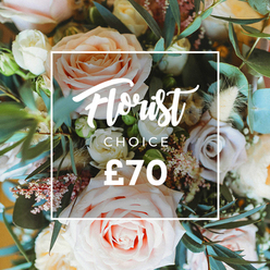 A close, overhead portrait of a premium florist-curated bouquet, rendered in whisper-soft pastels and natural textures that I often assemble at Flowers Golders Green for customers around Golders Green Road and the station area. The eye is drawn first to several large, fully blown roses in blush pink, creamy white and pale peach, their gently ruffled petals layered like soft fabric; interspersed are smaller blooms in a muted lavender-mauve that give the bouquet subtle shadow and variety. Tiny white filler blossoms-reminiscent of gypsophila or waxflower-and delicate clusters of pink seed-like buds thread through the composition, while creamy dried stems and airy grasses add a rustic, tactile rhythm to the design. Eucalyptus leaves, with their rounded shapes and dusty blue-green hue, provide cool contrast and structure, appearing like soft punctuation between the roses. Over the centre of the flowers a crisp white rectangular frame overlays the image; within it Florist Choice is written in a sweeping, elegant script, followed by a smaller uppercase CHOICE in a sans-serif, and the bold price ?70 sits at the bottom of the frame in striking white. The natural daylight and shallow depth of field give the bouquet a tranquil, romantic quality-perfect for gifts delivered across Golders Green, Temple Fortune and Hampstead Garden Suburb, and for anyone seeking a hand-picked arrangement that smells as fresh as it looks.
