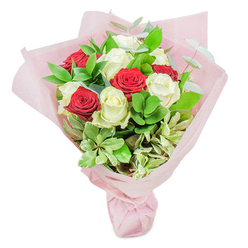 In this radiant composition, red and white roses come together like cherished neighbours in Golders Green, their striking colors catching the eye even from across a sunlit room. Each bloom is selected at peak freshness, with crimson petals opening in passionate fullness and creamy whites glowing with purity. The roses form a pleasing, rounded bouquet, tightly gathered and thoughtfully interspersed for a natural yet structured appearance. Between every rose, lush stems of garden-fresh foliage-deep green ruscus, silvery eucalyptus, and soft, cream-edged variegated leaves-provide grounding and dimension, echoing the textures one might find in the leafy streets near Golders Hill Park or Hampstead Heath Extension. The entire bouquet is lovingly enfolded in pearly pink wrapping, its diaphanous layers gently reflecting daylight and adding a lilt of romance. Whether intended for a birthday, a quiet moment of gratitude, or to mark a special day with someone dear in Golders Green, this arrangement radiates sincerity, artistry, and a sense of joyful anticipation. As a florist well-acquainted with the families and celebrations of our local community, I see in this bouquet not just flowers-but a bright, heartfelt gesture steeped in the colours and moods of NW11.