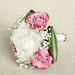 This romantic bouquet, lovingly arranged near the heart of Golders Green, radiates the warmth of a spring morning and the anticipation of a cherished celebration. The trio of pink roses, each layer of petal drifting from deep magenta tips to dreamy blush and lavender centers, evoke both passion and gentle affection. A creamy white peony, plush and fully open, anchors the arrangement with its sea of ruffled petals, lending creamy texture and lushness, much like the flourishing gardens tucked behind Golders Green's peaceful terraces. Wispy sprigs of Gypsophila thread between the roses and peony, casting a light, cloud-like veil that softens and unifies the composition. Framing the florals, broad emerald leaves provide a structured embrace, their glossy, folded forms echoing the green vitality found along Golders Green Road. The bouquet is hand-tied with a simple white satin ribbon, the handle extending gracefully for easy carrying-perfect for walks from Golders Green station to nearby wedding venues. The scene is set on a softly textured, neutral fabric, under diffused lighting that highlights every nuance and imparts an ethereal glow. Crafted with care and local expertise, this arrangement embodies devotion, new beginnings, and the unique charm of Golders Green's floral artistry.