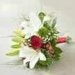 Seen from above on a soft, pale surface, this lush bouquet radiates classic elegance and vibrant modern charm-just like the Golders Green neighbourhood it calls home. Majestic trumpet-shaped white lilies, some open in full luminous glory and others still tightly budded, create a backdrop of purity and grace. Their gentle fragrance mingles with the deep, velvety crimson of a central red rose, unfurling at the core and symbolising deep romance. Interwoven among these are springy, textured moss-green floral spheres, likely green button chrysanthemums, which accentuate the arrangement's contemporary edge. Delicate sprigs of white baby's breath lighten the overall feel and hint at celebration. The rich, feathery foliage and glossy deep green leaves frame the blossoms, invoking the lush greenery of local gardens. Vivid pops from red hypericum berries accentuate the bouquet with festive energy. Neatly gathered and tied with a luxurious scarlet satin ribbon, the bouquet is ideal for weddings, anniversaries, or any heartfelt occasion in Golders Green, embodying sentiments of love, celebration, and the artistry of local florists.