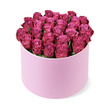 A sophisticated rose hat box arrangement is centred in the frame, photographed against a pristine white background that accentuates its colour and form. The hat box itself is a chic, cylindrical container in a pale blush-pink shade, with a smooth matte surface that hints at a velvety touch. From this understated base rises a lavish dome of deep pink, fuchsia, and magenta roses, each bloom carefully positioned so that together they create a perfectly rounded, overflowing crown. The tightly packed roses show delicate variations in tone, with softer pinks nestled toward their centres and richer, berry-like hues tracing the outer petals, giving the arrangement depth and a sense of gentle movement. The petals appear velvety and freshly opened, suggesting the cool softness you would feel when arranging them in a studio near Golders Hill Park. Just a few slivers of dark green foliage appear between the flowers, used sparingly to frame rather than compete with the sea of colour. Soft, even lighting reveals every curve of the petals and the smooth side of the hat box, while a faint shadow beneath the arrangement grounds it on the white surface, as if resting on a pristine counter in a Golders Green florist's shop. The composition feels both romantic and contemporary, conveying luxury without excess. It evokes the kind of thoughtful, high-end floral gift chosen for milestone birthdays, intimate celebrations, or heartfelt romantic gestures delivered across Golders Green and the surrounding NW11 neighbourhoods.