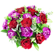 Set against a clean white backdrop and viewed from above, this sumptuous round bouquet seems to float like a colourful cloud, its richness perfectly suited to a stylish Golders Green apartment or townhouse. At its core, seven or eight red roses form the main visual anchor. Their petals are flawlessly shaped, spiralling from tight central whorls out into open, velvety blooms. Each rose shows a spectrum of red, from bright, romantic scarlet on the outer petals to deeper, almost garnet tones where the petals fold over one another, giving the impression of warmth and depth. Nestled closely around and between the roses, clusters of magenta and purple carnations create a plush, textured surround. Their frilly, serrated petals form layers upon layers of soft ruffles, some blossoms glowing in vivid fuchsia, others shifting into darker plum and royal purple, like the play of shadows and light along nearby Golders Green Road at dusk. Lush foliage frames and supports the blooms, filling the circular outline with green. Silvery-green eucalyptus, with its round, slightly matte leaves, adds a cool, soothing note, while darker, glossy leaves-resembling Ruscus or Salal-provide a strong, structured backdrop. Finer, lighter green sprigs weave between the larger leaves and blooms, reinforcing the natural, freshly gathered look. The bouquet appears full, balanced, and carefully designed, each element enhancing the others. The combination of passionate reds, joyful purples, and layered greens creates an atmosphere of celebration and heartfelt emotion, ideal for birthdays, anniversaries, or simply sending love and appreciation with same-day flower delivery across Golders Green and the surrounding North London streets.