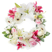A beautifully crafted circular funeral wreath is presented against a clean white background, its open centre surrounded by an unbroken ring of white, pink, and deep magenta flowers that feels both comforting and dignified. Tall, elegant white lilies form the main structure, their wide, trumpet-like petals gently arching outwards, each bloom showing soft green throats and delicate golden stamens that hint at a light, sweet fragrance. Interspersed with them are rich fuchsia and deep pink lilies, some patterned with fine speckles, which add a vibrant yet respectful contrast, like deeper notes in a quiet piece of music. Between these statement flowers, soft light pink roses and creamy white roses are nestled closely together, some in tight buds, others opening to reveal layered, velvety petals that suggest tenderness and affection. White gerbera daisies, with their dark centres and radiating petals, brighten the design and bring a crisp, contemporary edge that still feels suitable for a solemn occasion. Smaller white filler flowers, possibly spray carnations or miniature chrysanthemums, are woven throughout to fill every gap, creating a plush, seamless texture. Around and beneath the flowers, variegated and deep green foliage curves along the wreath, adding depth, framing the circle, and grounding the bright blooms in natural greenery. This arrangement has the calm, composed presence of the sympathy wreaths often chosen by families in Golders Green, Hampstead Garden Suburb, and along Finchley Road, making it a meaningful floral tribute for funerals, cremation services, or memorials that honour a life with grace and quiet beauty.