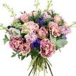 Set against a clean white background, this lush, hand-tied bouquet looks like it has been freshly arranged in a Golders Green studio and placed down for a moment of stillness. The flowers form a rounded, abundant cluster where every space is filled, creating a soft yet richly detailed tapestry of colour and texture. At the heart of the design, roses in tones of dusty pink and soft peach unfurl in different stages of opening: some petals spiralling wide to reveal their full, velvety faces, others remaining half-closed, adding a sense of promise and longevity. Around them, frilled carnations in a striking two-tone palette-magenta edges melting into creamy, blush centres-build volume and lend a beautifully ruffled, almost cloud-like appearance. Threaded throughout are deep indigo and violet-blue anemones, their signature dark eyes adding drama and a contemporary twist to the otherwise gentle palette. Vertical accents come from stems of lavender and pale pink stock, their many small blossoms clustered tightly along each stem, giving the bouquet a slightly airy, feathery quality that calls to mind evening walks past front gardens off Hoop Lane. Silvery-green eucalyptus leaves curve between the blooms, their cool tone balancing the warmer petals, while darker, more robust foliage sits underneath, creating a lush, supportive base. The natural stems are visible and neatly gathered at the bottom, emphasizing the bouquet's hand-crafted, organic feel. Bathed in clear, even lighting that captures every delicate crease and colour shift, the arrangement conveys elegance without being formal-ideal for a romantic surprise, a thoughtful get-well message, or a refined thank-you delivered to homes and offices throughout Golders Green.