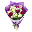 Captured against a clean white background, this bouquet appears as a radiant burst of colour and texture, carefully hand-crafted to feel both contemporary and romantic. Cream-white roses rise proudly at the centre, each blossom composed of layered, velvety petals that spiral inward, hinting at a gentle, classic rose fragrance. Surrounding them are deep magenta and fuchsia carnations, their ruffled petals forming cloud-like tufts of intense colour that instantly draw the eye, much like a vibrant shopfront display along Golders Green High Road. Interspersed among the richer hues, slender white alstroemeria blooms open gracefully, each petal marked with fine streaks of pinkish red and anchored by dark stamens, giving a delicate, speckled effect that adds refinement and intricacy to the overall look. Lush green leaves - some a vivid, solid green, others brushed with lighter variegated edges - fill the gaps between blossoms, ensuring the bouquet feels rounded, full, and lively rather than rigid or formal. The arrangement is shaped into a smooth, domed crown of flowers, with the stems gathered tightly below so that the whole bouquet narrows elegantly towards the base, ready to be carried to a doorstep in nearby Hampstead Garden Suburb or delivered as a surprise gift after work. An inner layer of crisp white paper forms a smart, structured collar around the blooms, providing a clean visual border. Over this, a layer of translucent, gently crinkled purple cellophane or paper surrounds the stems, adding a subtle shimmer and enhancing the jewel-like tones of the flowers within. At the very base, the wrapping is cinched with a bright, iridescent green satin ribbon tied into a neat bow, a small, light brown gift tag dangling invitingly from the knot. The entire arrangement conveys warmth, celebration, and thoughtful intention, making it perfect for birthdays, congratulations, or simply brightening someone's day in Golders Green.