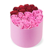 Presented in a light pink, matte round cylindrical gift box, this vibrant rose display rests on a clean white backdrop, yet within Golders Green it feels tailor-made for a romantic gesture. The box is brimming with fresh blossoms, roses arranged to carve a striking heart shape across the lid, the top lobes formed by about twelve deep red roses-crimson and confident-while the lower curve fills with a larger cluster of blush pink roses that melt into the lighter end of the palette. The petals are tightly furled in perfect spirals, then unfurl to reveal velvet layers and a soft satin sheen as the light travels across them. The arrangement reads as a modern love letter: bold color contrast, meticulous spacing, and a sense of quiet abundance that avoids any hint of overcrowding. The soft box itself, a pastel pink that reads almost like velvet, contrasts with the crisp white surface behind it, letting the two tones sing together. This luxurious gift evokes Valentine's, anniversaries, or a celebratory moment at home-an elegant centerpiece or a thoughtful delivery that carries warmth from Golders Green to nearby Hampstead Garden Suburb and beyond. The scent is gentle, the texture inviting to touch, and the visual balance between heart-shaped silhouette and architectural box makes this a refined, enduring gift that feels crafted with care by Flowers Golders Green.