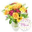 A warm, celebratory bouquet sits against a crisp white background, arranged in a simple clear glass vase so the trimmed green stems and fresh water are visible. The composition leans slightly to the left: generous, peachy-orange roses with fully unfurled petals form the visual heart, their velvety spirals catching soft, even light. Scattered among them are sunny yellow gerbera daisies with their broad, radiant faces and dark brown centers that read like small suns against the warmer roses. Deep burgundy carnations add a plush, ruffled texture and visual weight, their layered petals providing a rich contrast to the lighter blooms. Slender white alstroemeria with speckled throats peek through, lending a delicate, almost porcelain note and a faint floral perfume when imagined up close. A generous cloud of glossy green foliage-broad leaves and feathery sprigs-cradles the flowers and gives the arrangement a natural, garden-fresh volume. To the lower right, slightly overlapping the base of the vase, a round white foil balloon sits playfully; it is printed with scattered gold and bright pink polka dots and tiny hearts, and an elegant hot-pink script reads best Mum, the sentiment curving with the balloon's shine. The overall effect is joyful and intimate, suited to Mother's Day, a birthday, or a quiet moment of thanks. As a Golders Green local florist would describe it, the arrangement blends tactile textures, clear seasonal colours, and a personalised touch-a present that looks as lively by morning light as it does under a lamp on a celebratory evening.