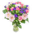 This bouquet feels like a gentle poem composed in petals and light-a dance of silken pink roses and soft gerberas, their pastel hues gleaming against a deep backdrop of lush greenery in the heart of Golders Green. Each rose, from its initial curl to its blooming spiral, speaks of budding romance and tender appreciation-a fitting tribute to the neighbourhood's history and quiet beauty. The gerberas add a clean, open cheerfulness, while unexpected bursts of vivid violet statice lend a playful contrast, evoking wildflowers one might stumble upon near the Heath Extension. The bouquet's green foliage breathes life into the scene, infusing it with an aromatic freshness that hints at early mornings strolling through Golders Hill Park. This arrangement is both airy and abundant, simultaneously spirited and serene-crafted for moments of joy, whether a birthday breakfast in a local café or a heartfelt congratulations. Every bloom is selected for meaning as well as beauty, ensuring that when it arrives at a doorstep in NW11, the recipient feels truly seen and cherished, the care of a Golders Green florist woven into every stem.